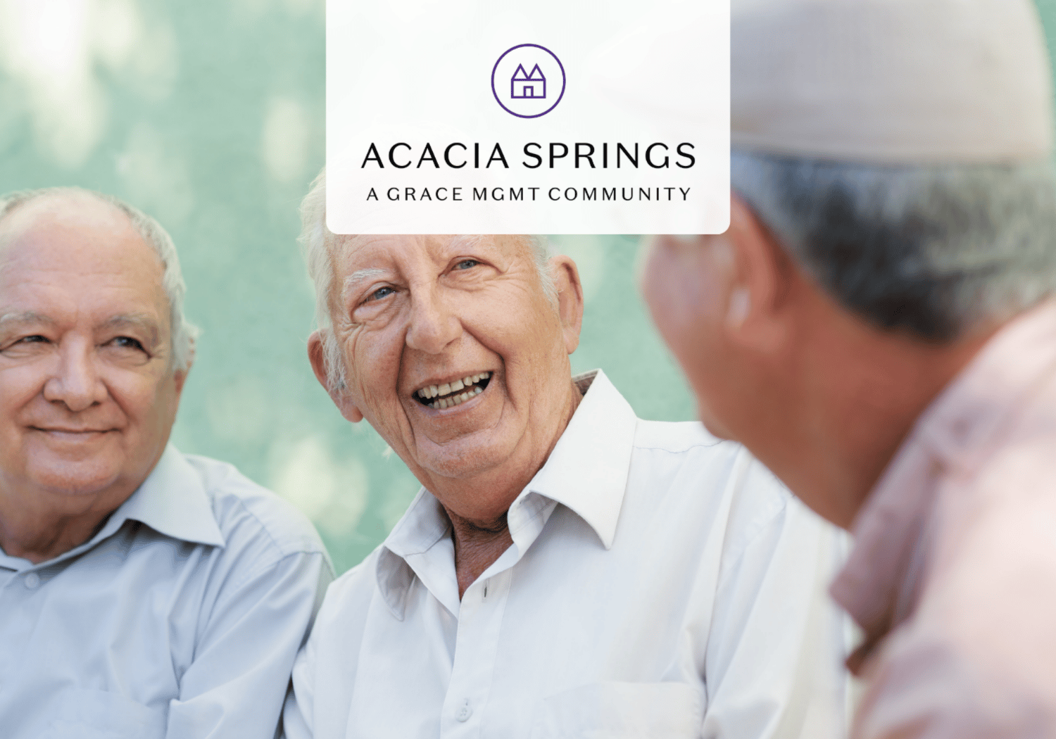 Three smiling elderly men chatting outdoors with a white overlay showing the Acacia Springs logo and tagline, signaling a senior living community.